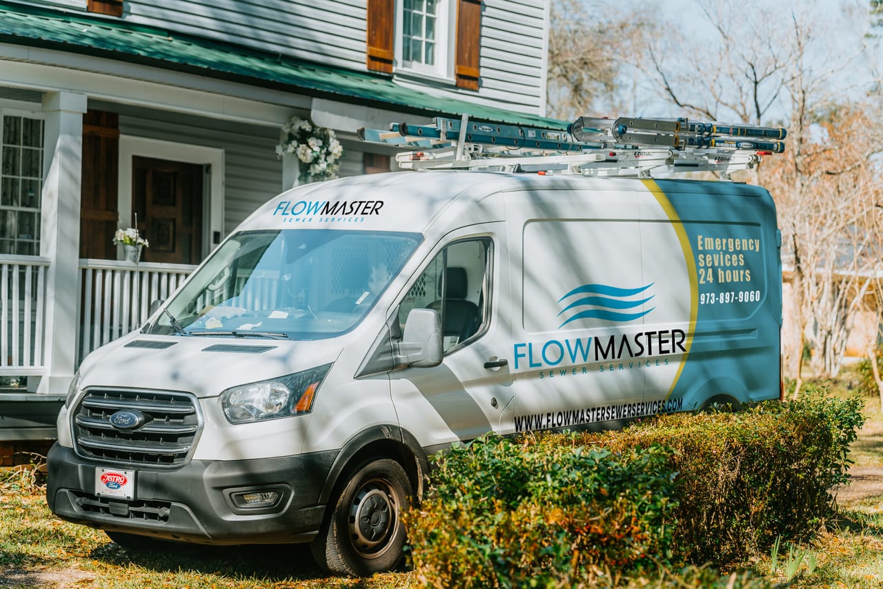 FlowMaster service van parked in front of a North Jersey home